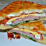 A breakfast panini loaded with meats, cheese,veggies.