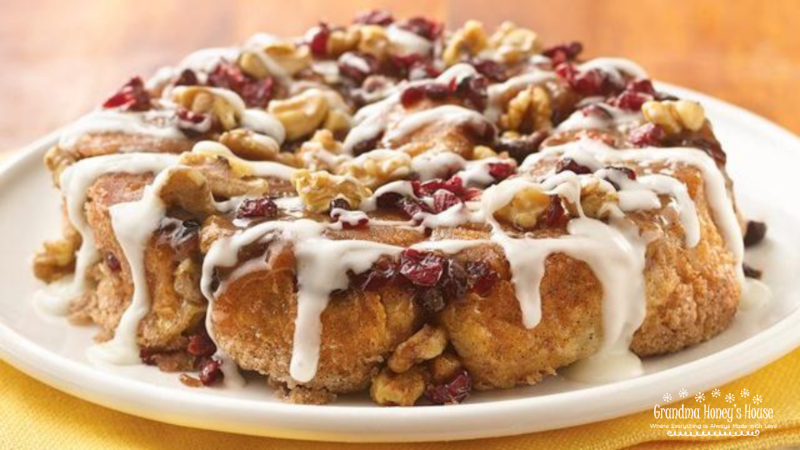 A delicious, easy brunch recipe. Refrigerated biscuits stuffed with mascarpone cheese, rolled in butter-cinnamon-sugar. Sprinkled with cranberries and nuts. Drizzled with a rich icing. 