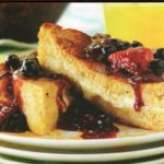 French toast stuffed with mascarpone cheese filling and topped with fresh berry sauce.