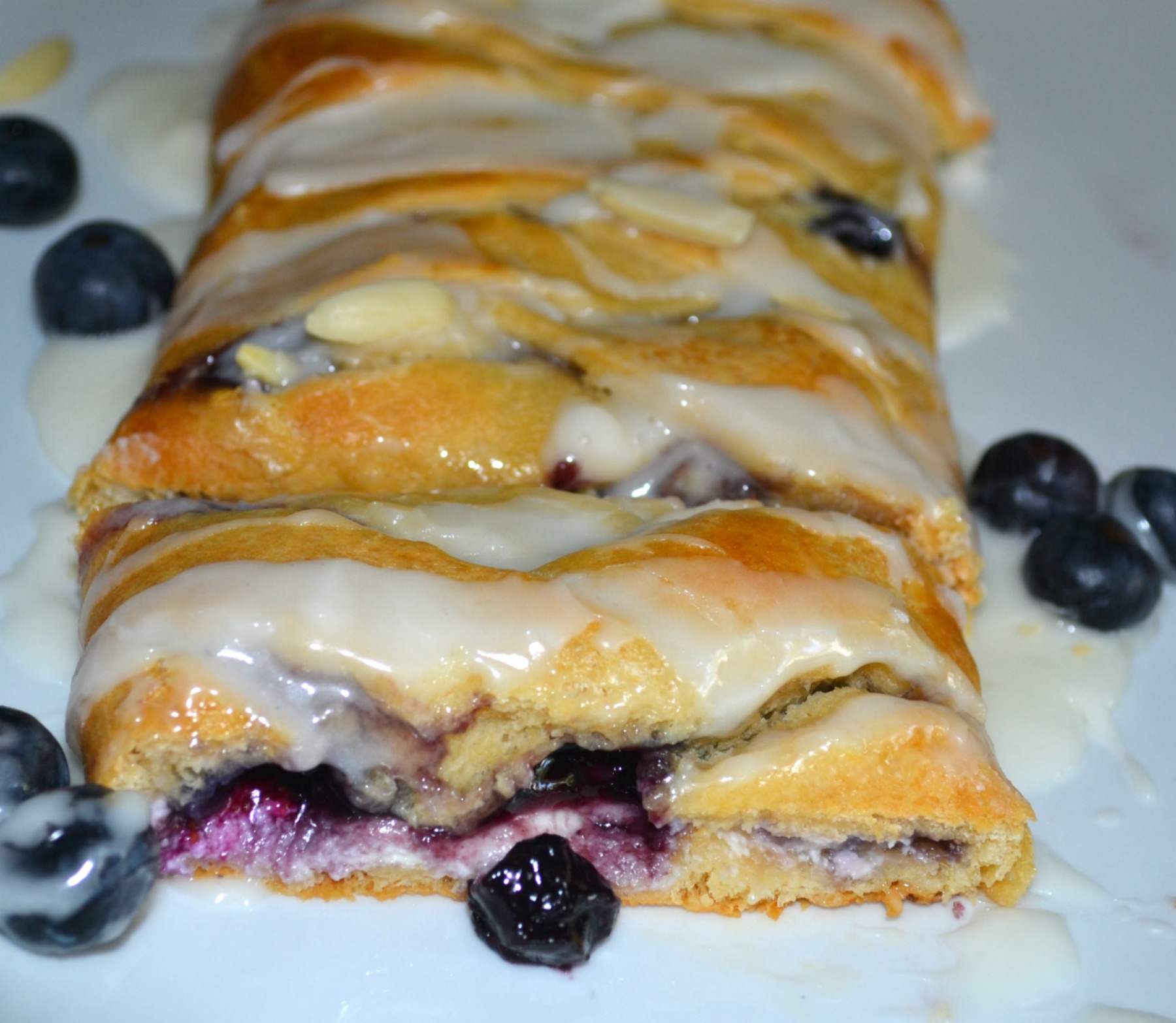 This easy breakfast braid is filled with cream cheese and blueberries then wrapped in a crescent crust. It is baked and topped with a warm, sweet glaze.