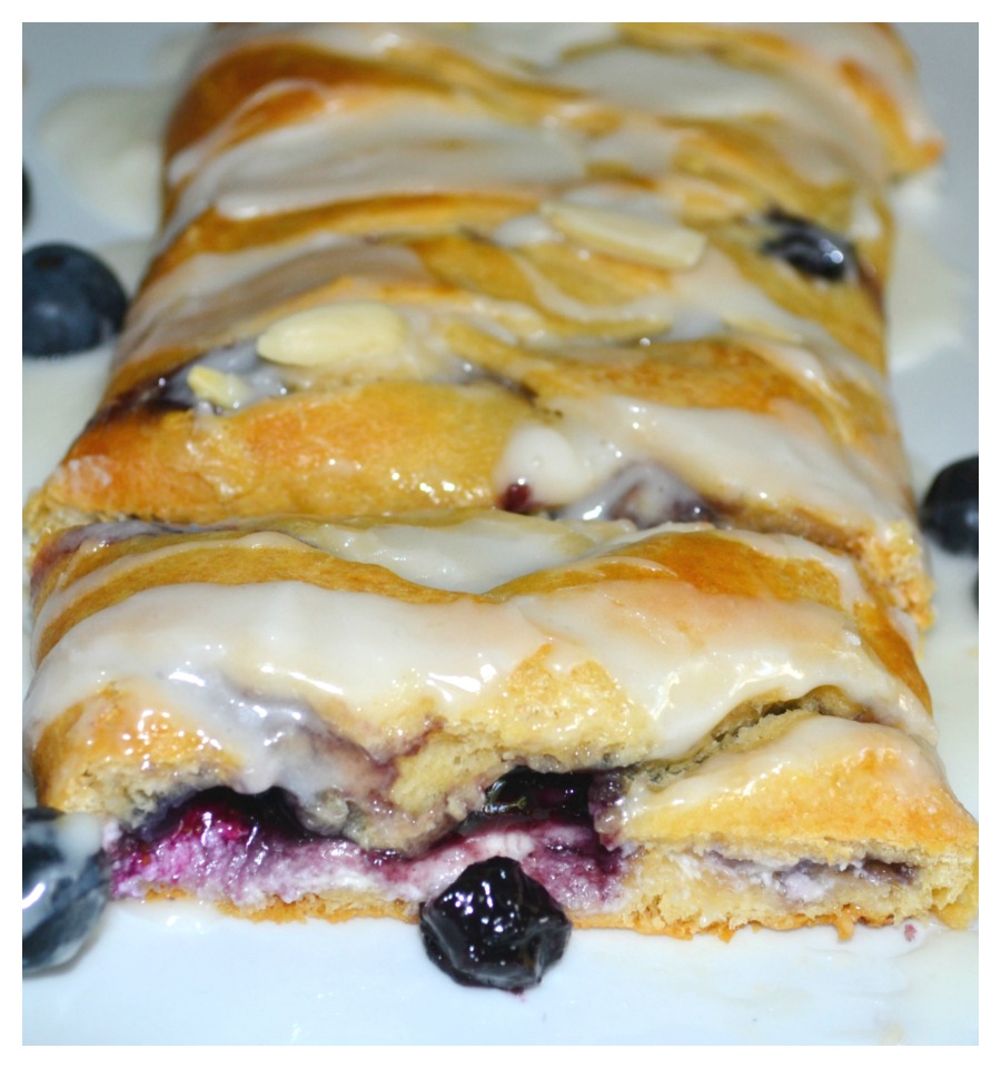 This easy breakfast braid is filled with cream cheese and blueberries then wrapped in a crescent crust. It is baked and topped with a warm, sweet glaze.