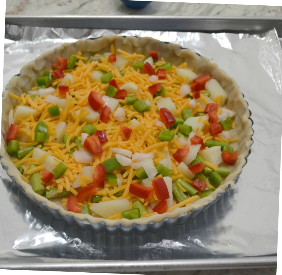 A delicious brunch tart filled with fresh veggies, eggs and cheese. Perfect way to use those summer vegetables.