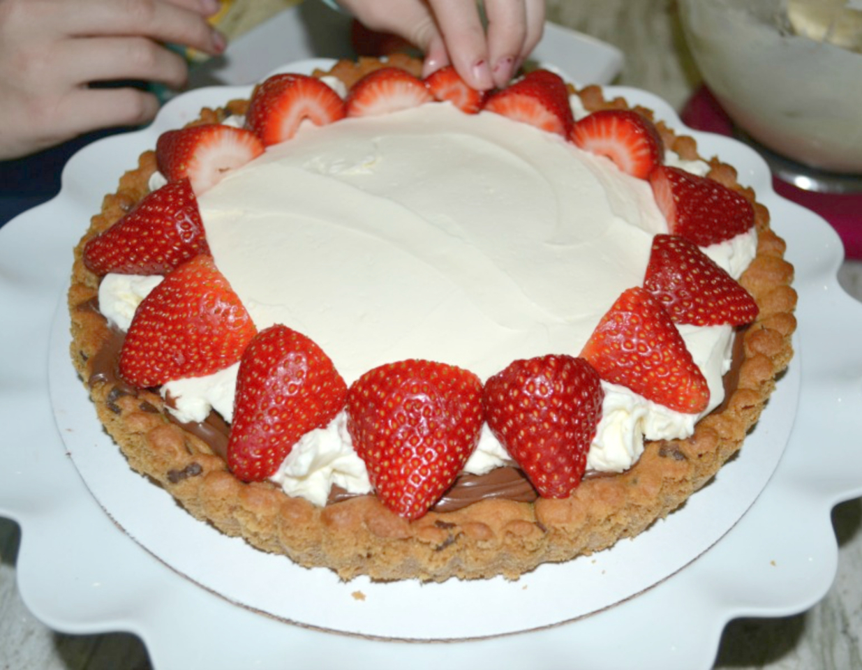 Strawberry Mascarpone Hazelnut Chocolate Tart is an easy yet elegant dessert made with a refrigerated chocolate chip cookie crust, creamy mascarpone filling, chocolate hazelnut spread, and fresh strawberries on top.