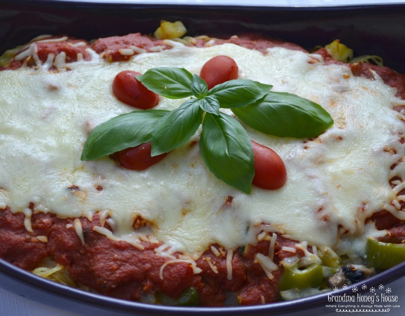 Cheesy Garden Patch Spaghetti bake is loaded with veggies, sauce, pasta and cheese. 