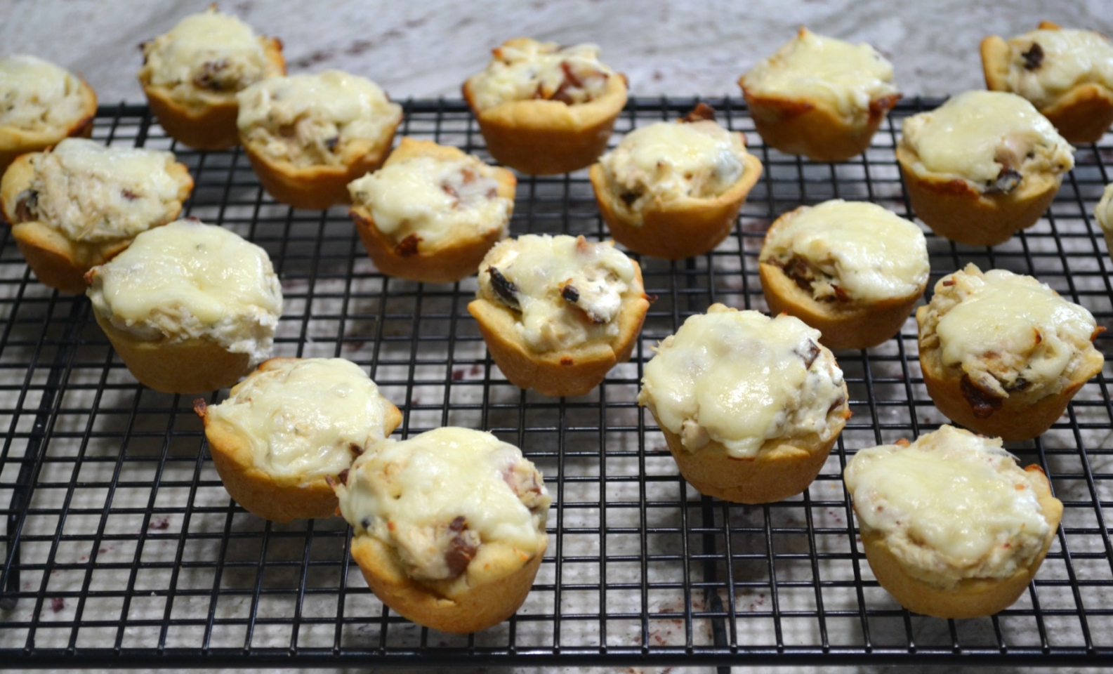 Chicken-Bacon-Caprese Bites are perfect to add to your tailgate menu. Chicken, cheese and a caprese topping baked in a crescent dough cup