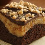 A rich dessert with a brownie based, topped with peanut butter, cream cheese, toffee bits and chocolate.