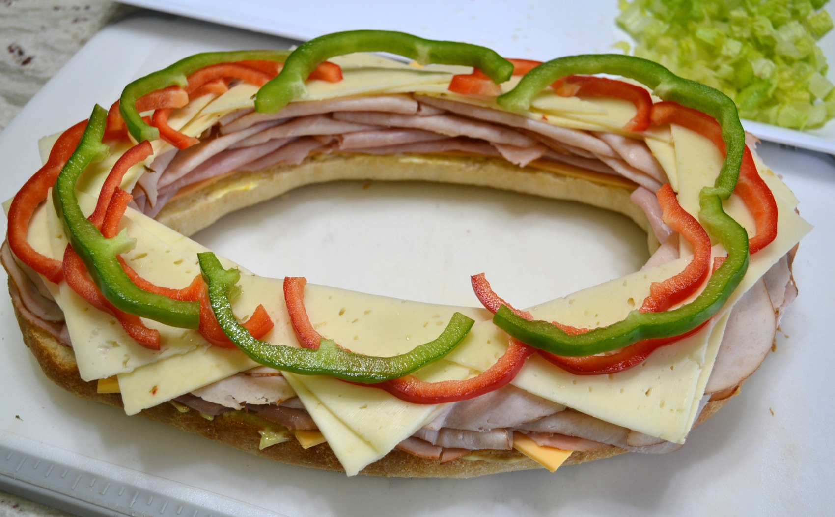 This Sensational Stadium Sandwich is packed with meat, cheese, and veggies. Perfect to serve at any tailgate party