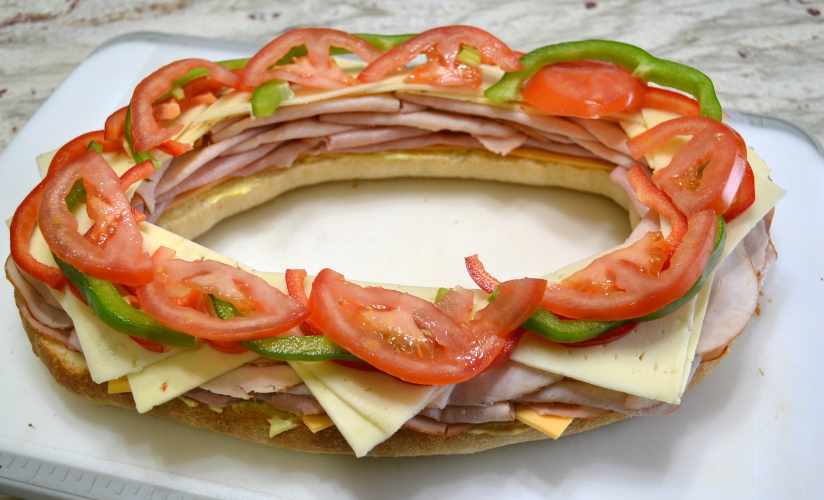 This Sensational Stadium Sandwich is packed with meat, cheese, and veggies. Perfect to serve at any tailgate party
