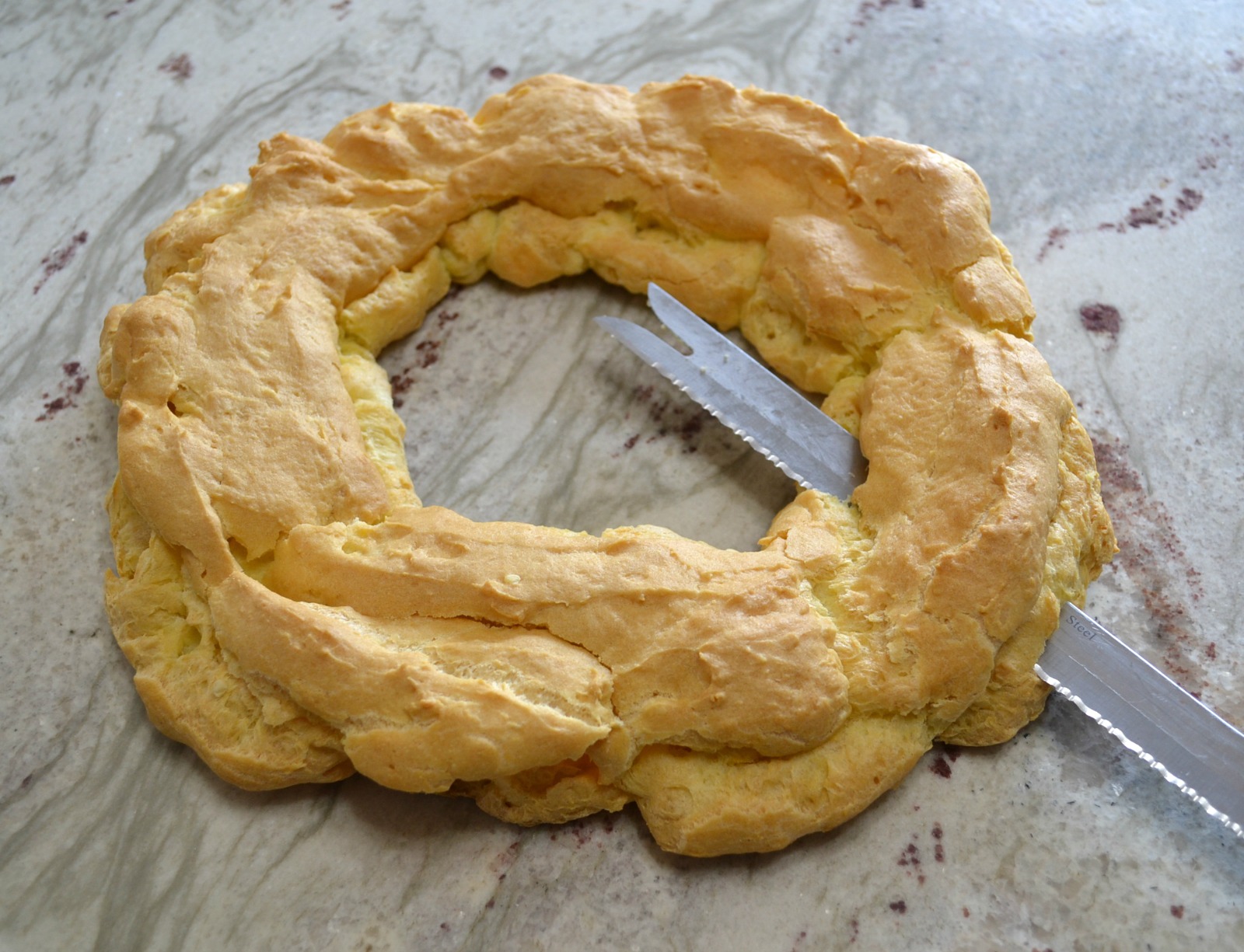 This elegant dessert is a cream puff ring filled with pudding and cherry pie filling.