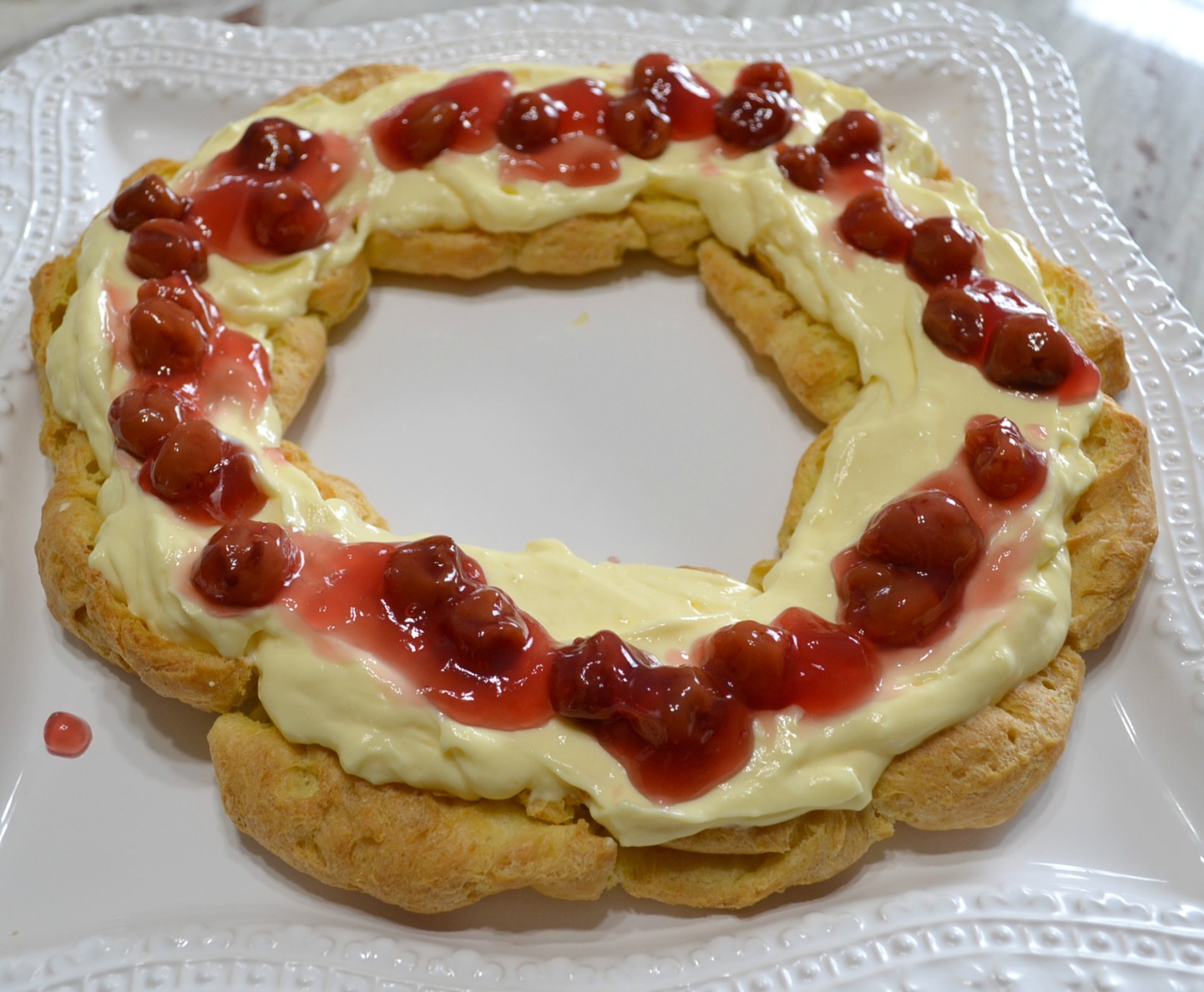 This elegant dessert is a cream puff ring filled with pudding and cherry pie filling. 