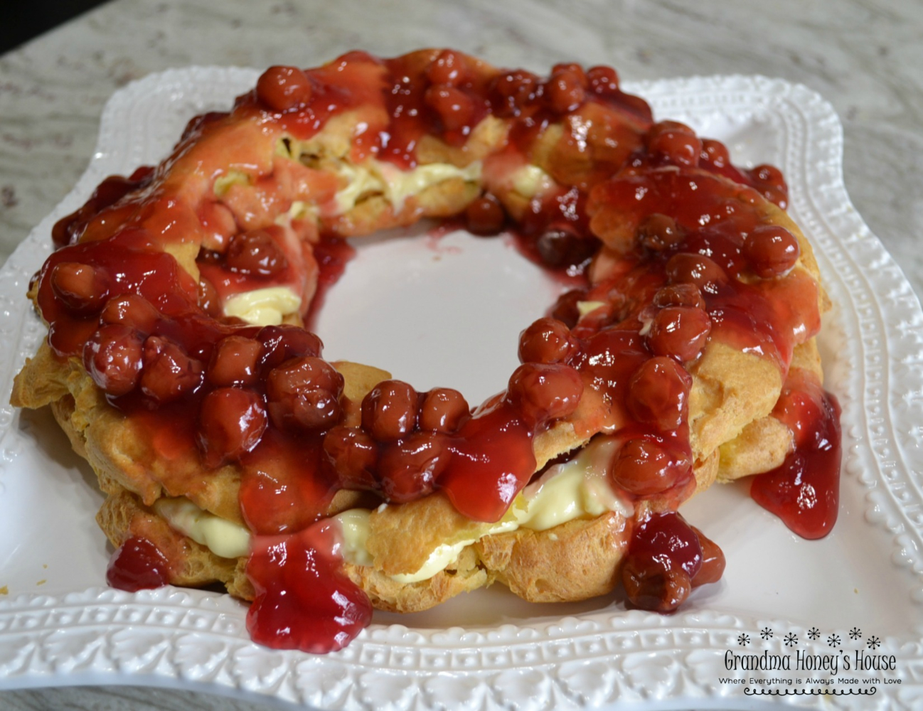 This elegant dessert is a cream puff ring filled with pudding and cherry pie filling. 