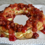 This elegant dessert is a cream puff ring filled with pudding and cherry pie filling.