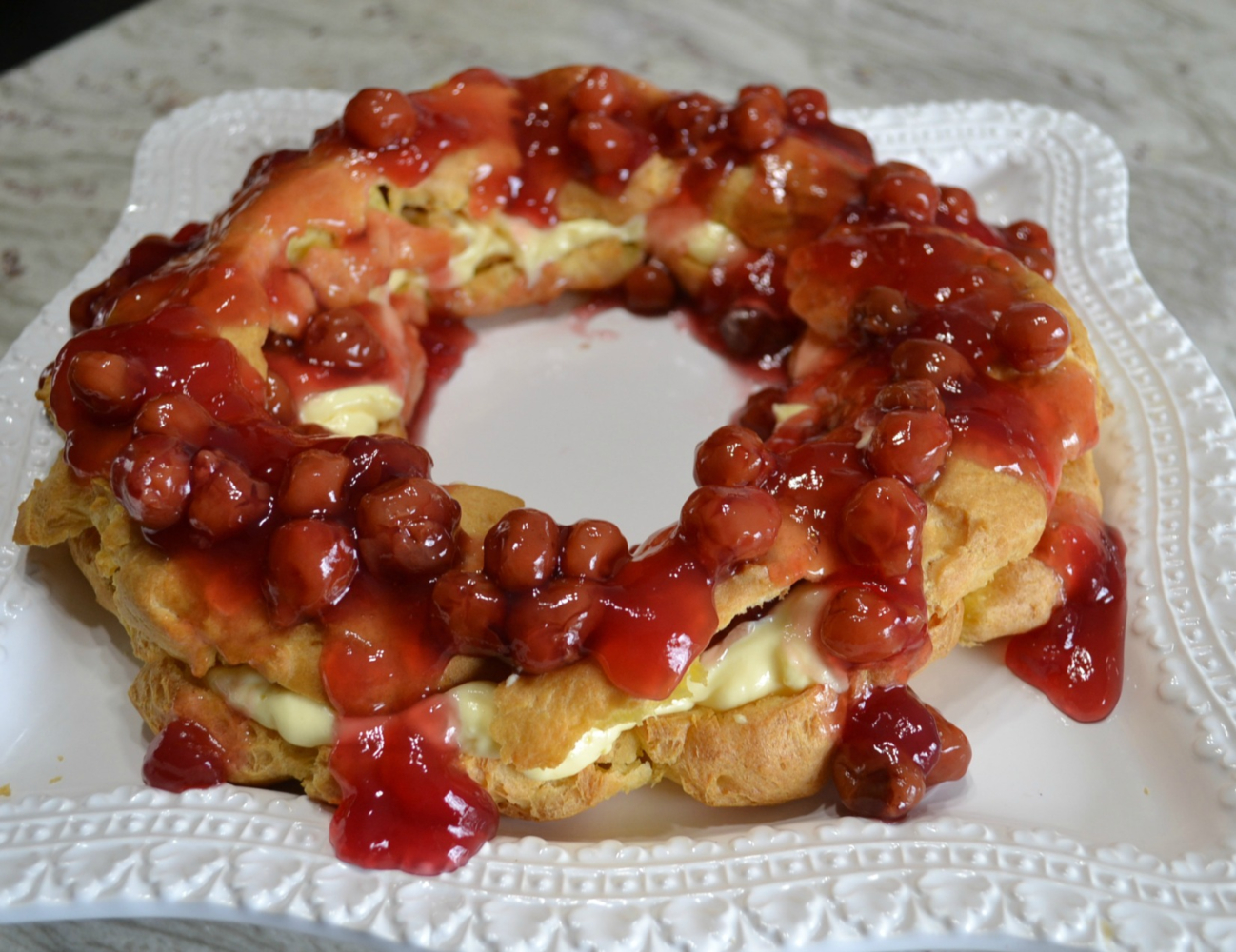 This elegant dessert is a cream puff ring filled with pudding and cherry pie filling.