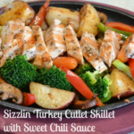 A sizzlin skillet filled with colorful veggies, sliced turkey cutlets and drizzled with sweet chili sauce.