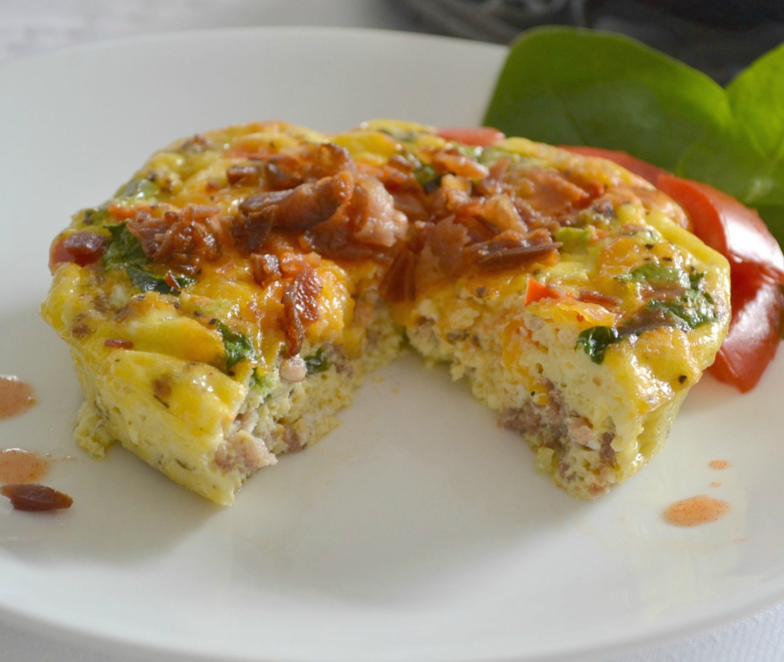 Mini Frittatas loaded with bacon ham, sausage, eggs, cheese, and veggies baked in a mini cast iron skillet.