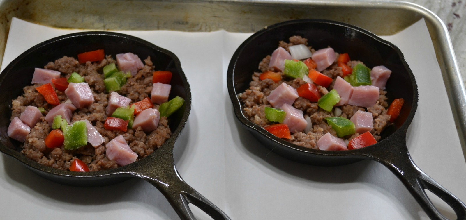 Mini Frittatas loaded with bacon ham, sausage, eggs, cheese, and veggies baked in a mini cast iron skillet.