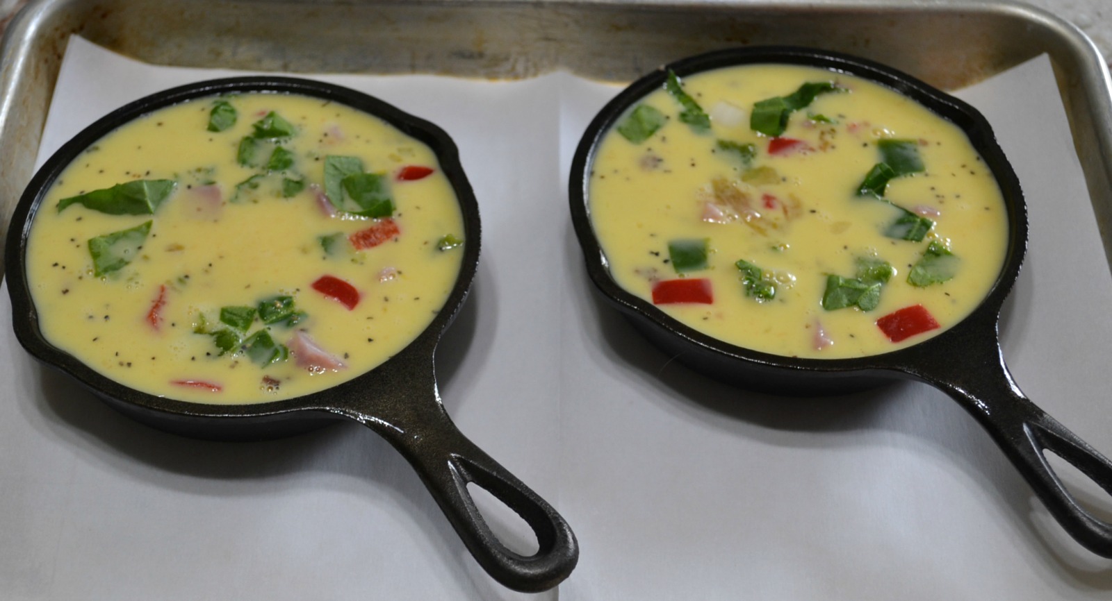 Mini Frittatas loaded with bacon ham, sausage, eggs, cheese, and veggies baked in a mini cast iron skillet.