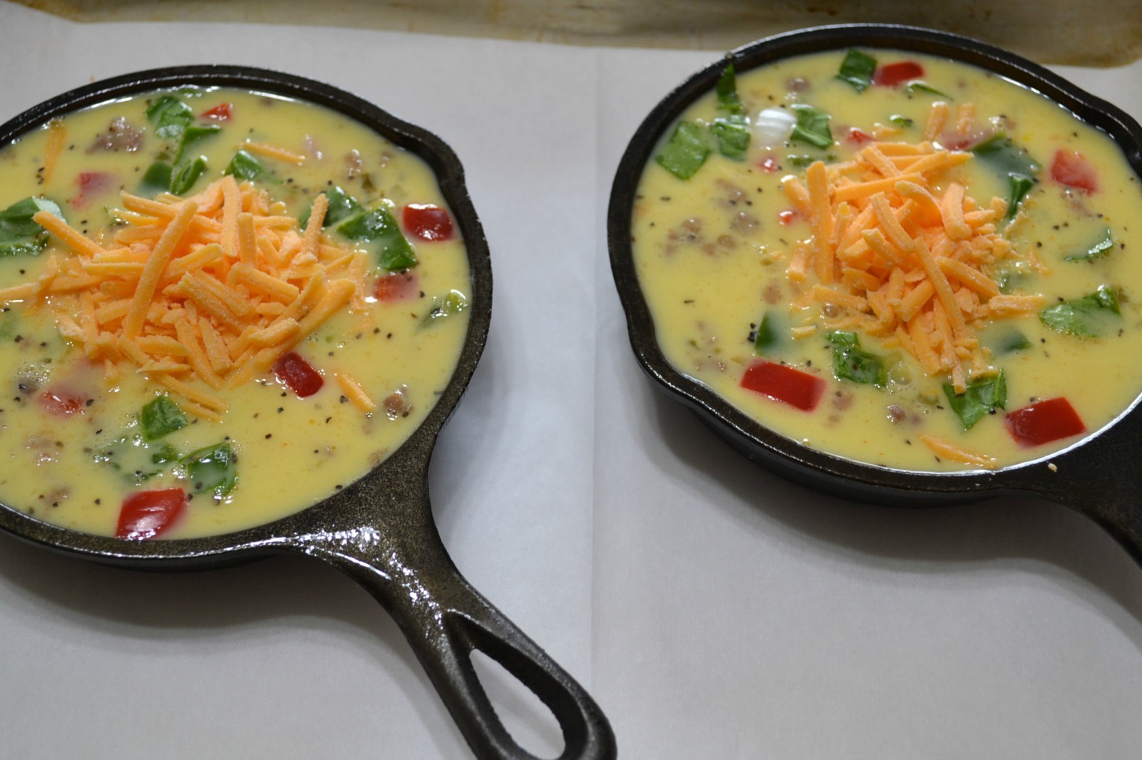 Mini Frittatas loaded with bacon ham, sausage, eggs, cheese, and veggies baked in a mini cast iron skillet.