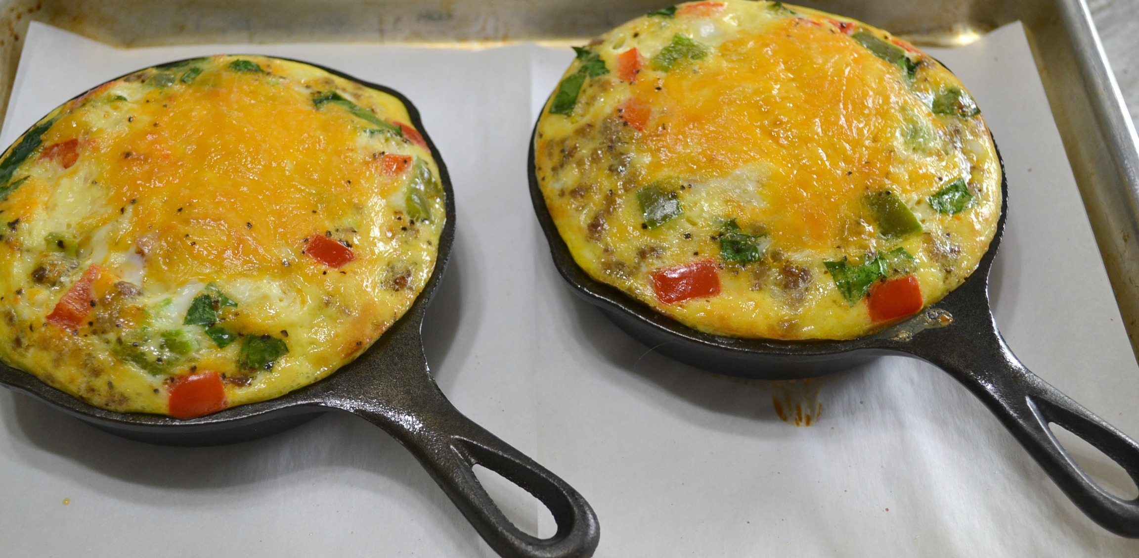 Mini Frittatas loaded with bacon ham, sausage, eggs, cheese, and veggies baked in a mini cast iron skillet.