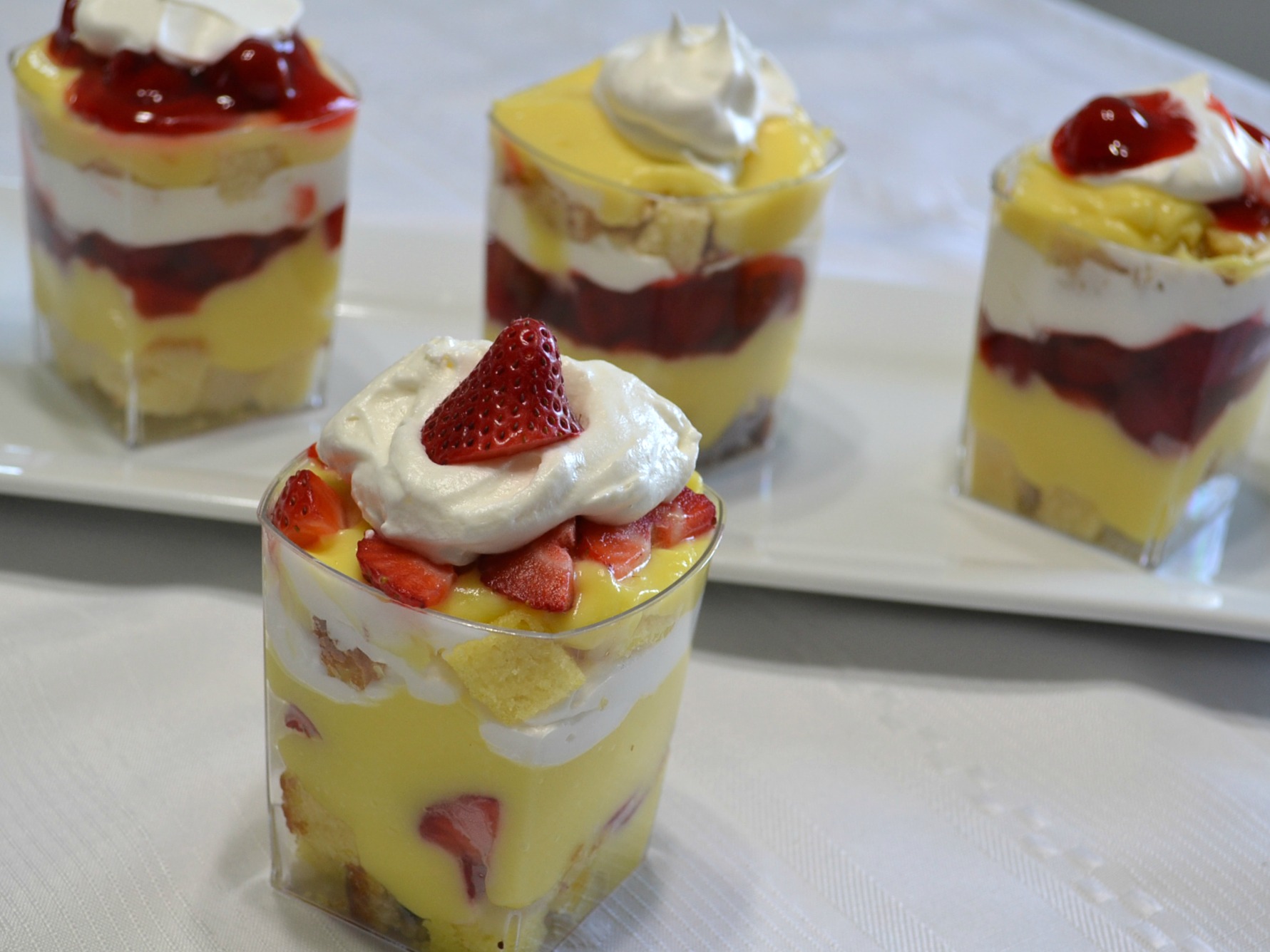 Punch bowl cake arranged in individual plastic cups. A variety of ingredients make them colorful and delicious.