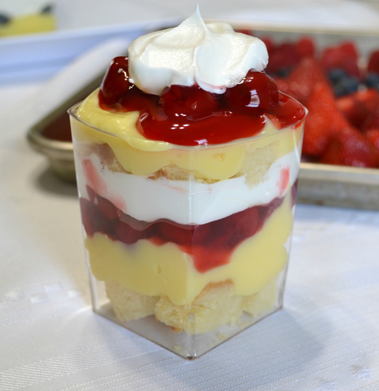 Punch bowl cake arranged in individual plastic cups. A variety of ingredients make them colorful and delicious.