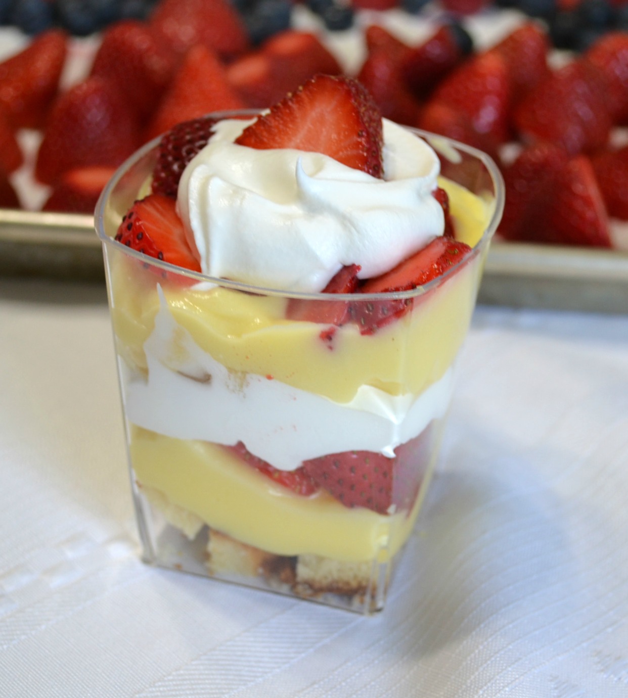 Punch bowl cake arranged in individual plastic cups. A variety of ingredients make them colorful and delicious.