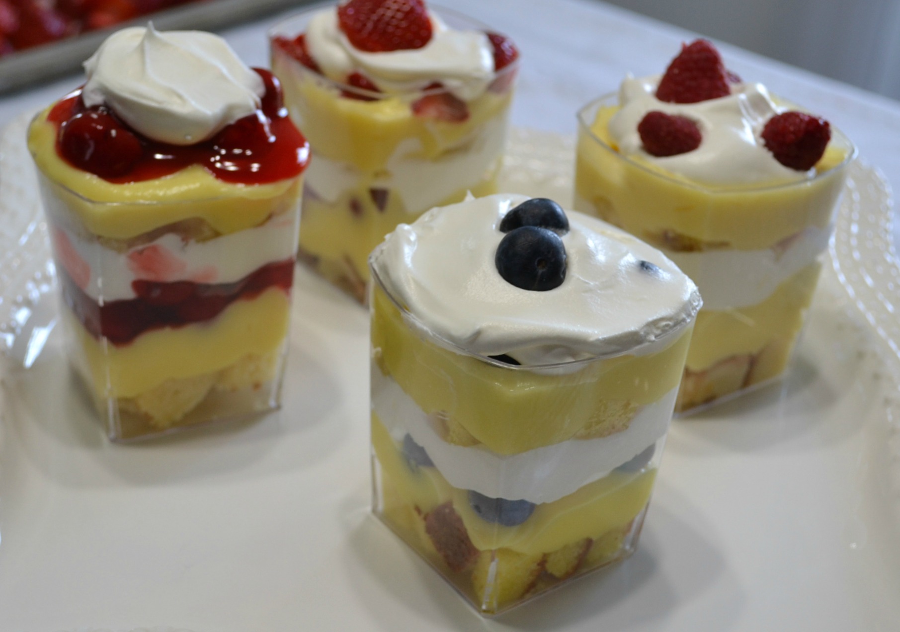 Punch bowl cake arranged in individual plastic cups. A variety of ingredients make them colorful and delicious.