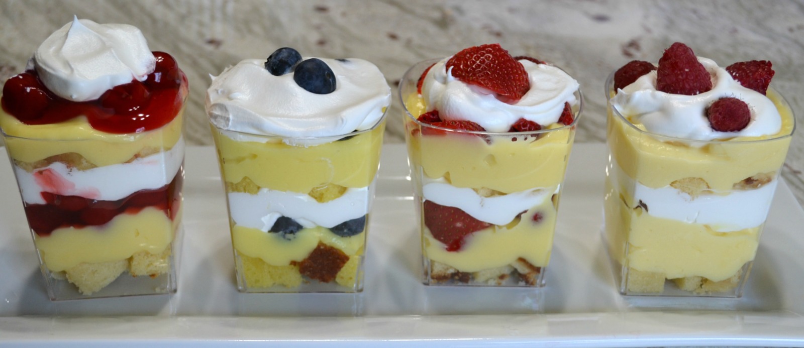 Punch bowl cake arranged in individual plastic cups. A variety of ingredients make them colorful and delicious.