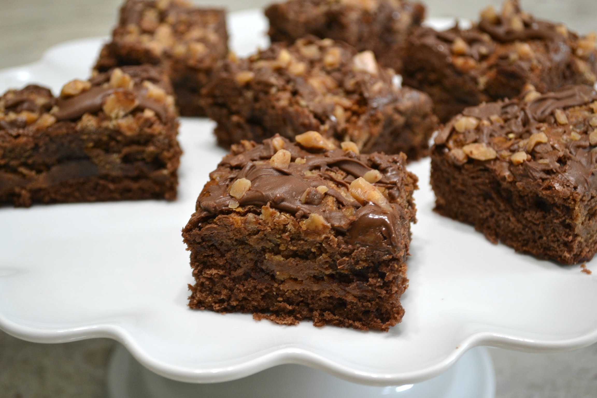 A decadent brownie dessert made with a can of chocolate flavored sweetened condensed milk, peanut butter, and toffee bits