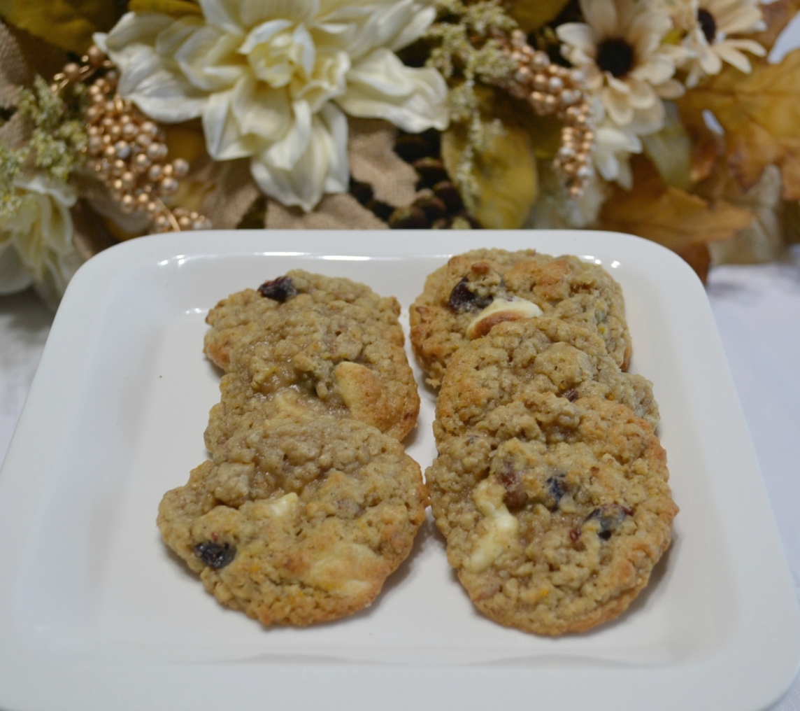 A flavorful oatmeal cookie packed with flavors from cranberry, pecans, and orange zest topped with a melted white chocolate drizzle.