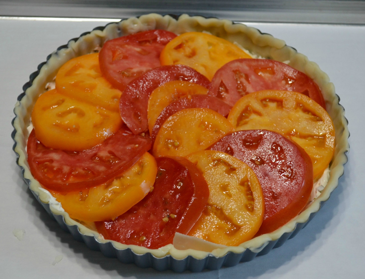 This Garden Fresh Tomato Bacon Tart is a crust filled with chive & onion cream cheese,fontina,fresh tomatoes,bacon and seasonings. Perfect for summertime eating