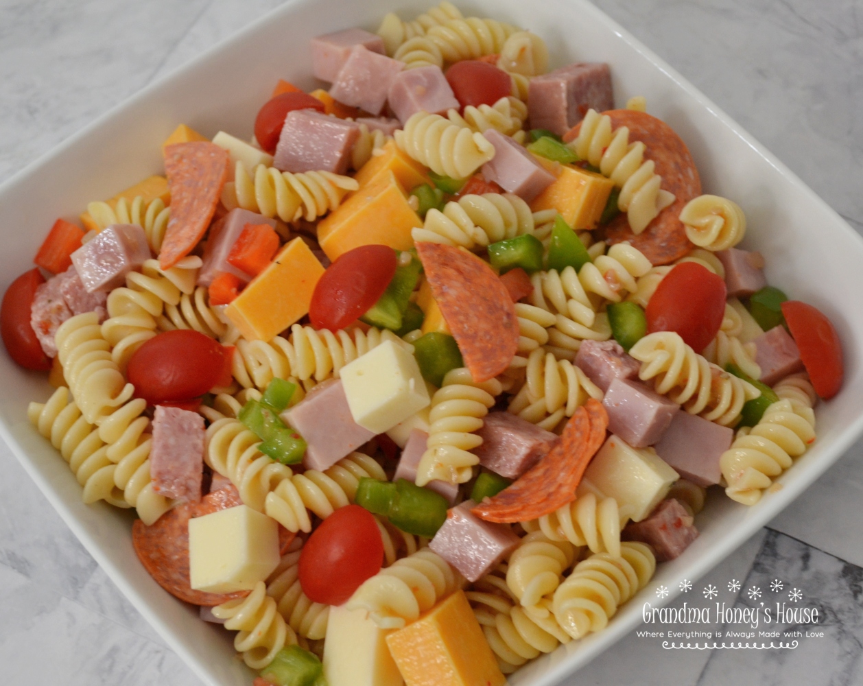 This Protein Packed Pasta Salad is loaded with veggies, meats, and cheeses. Colorful, delicious, and perfect to transport to any summer event.