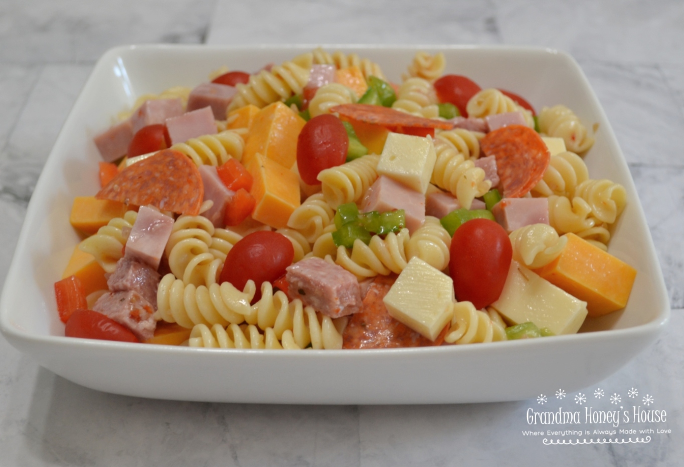This Protein Packed Pasta Salad is loaded with veggies, meats, and cheeses. Colorful, delicious, and perfect to transport to any summer event.