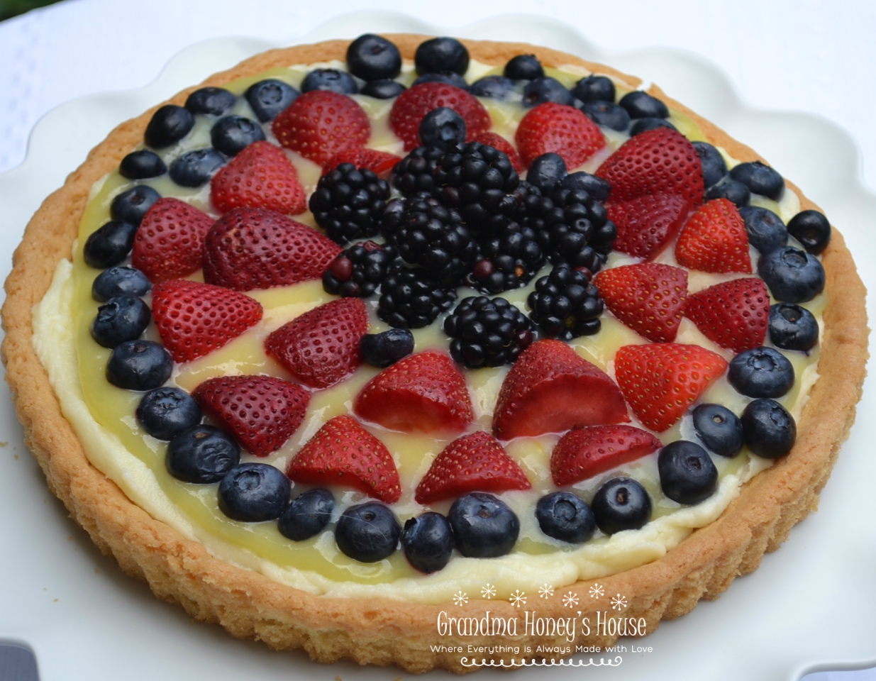 Berry Lemon Mascarpone Cookie Tart is made with a sugar cookie crust that is filled with sweetened mascarpone cheese, lemon curd, and topped with fresh berries.