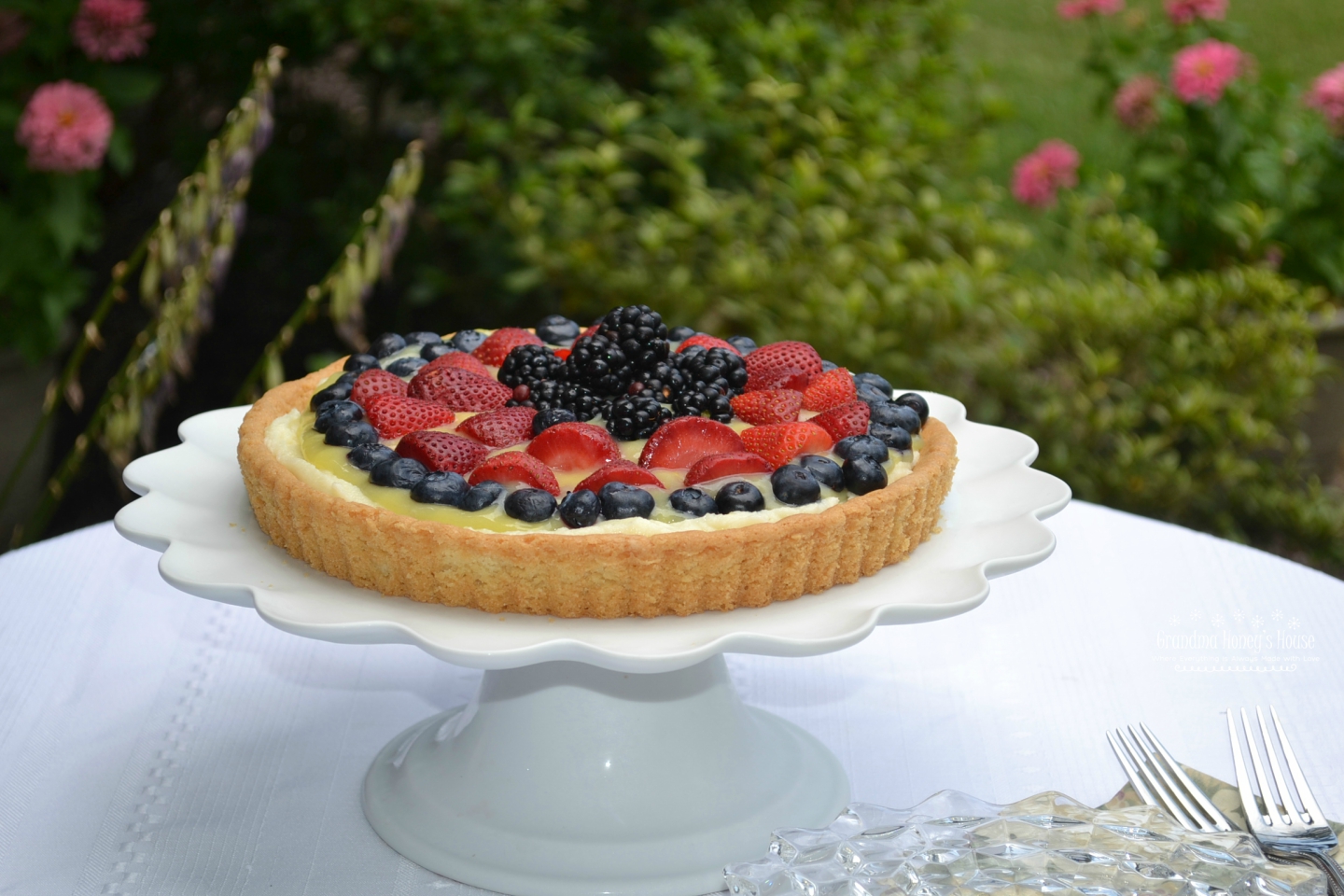 Berry Lemon Mascarpone Cookie Tart is made with a sugar cookie crust that is filled with sweetened mascarpone cheese, lemon curd, and topped with fresh berries.