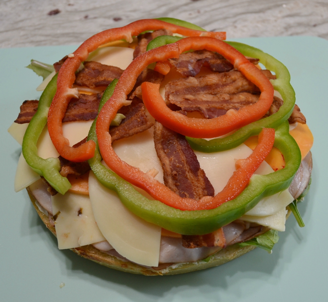 Picnic Foccacia Sandwich is loaded with meats, cheeses,and veggies. Made on a foccia loaf, drizzled with italian dressing and cut into beautiful wedges