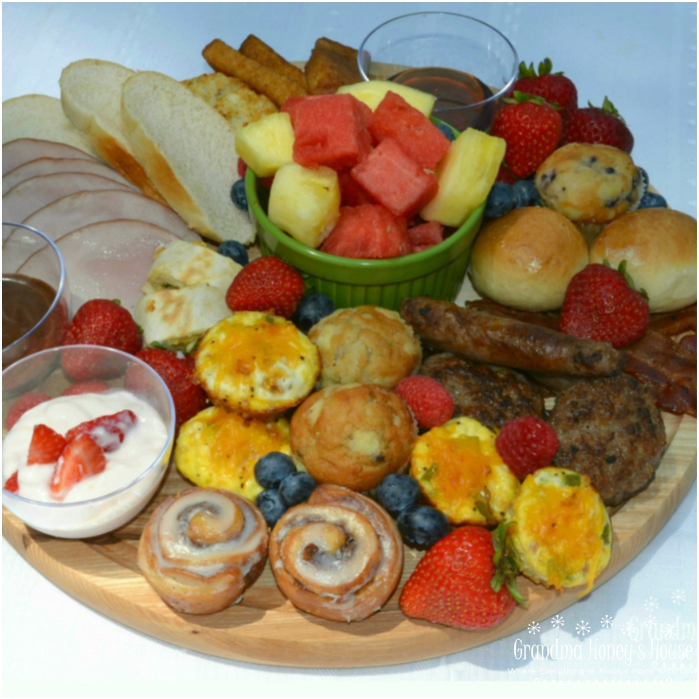 This Brunch Board for 2 is a delicious and fun way to enjoy a start to your day. A round, wooden cutting board is filled with a variety of breakfast foods, fresh fruits, dips, and sweet treats.