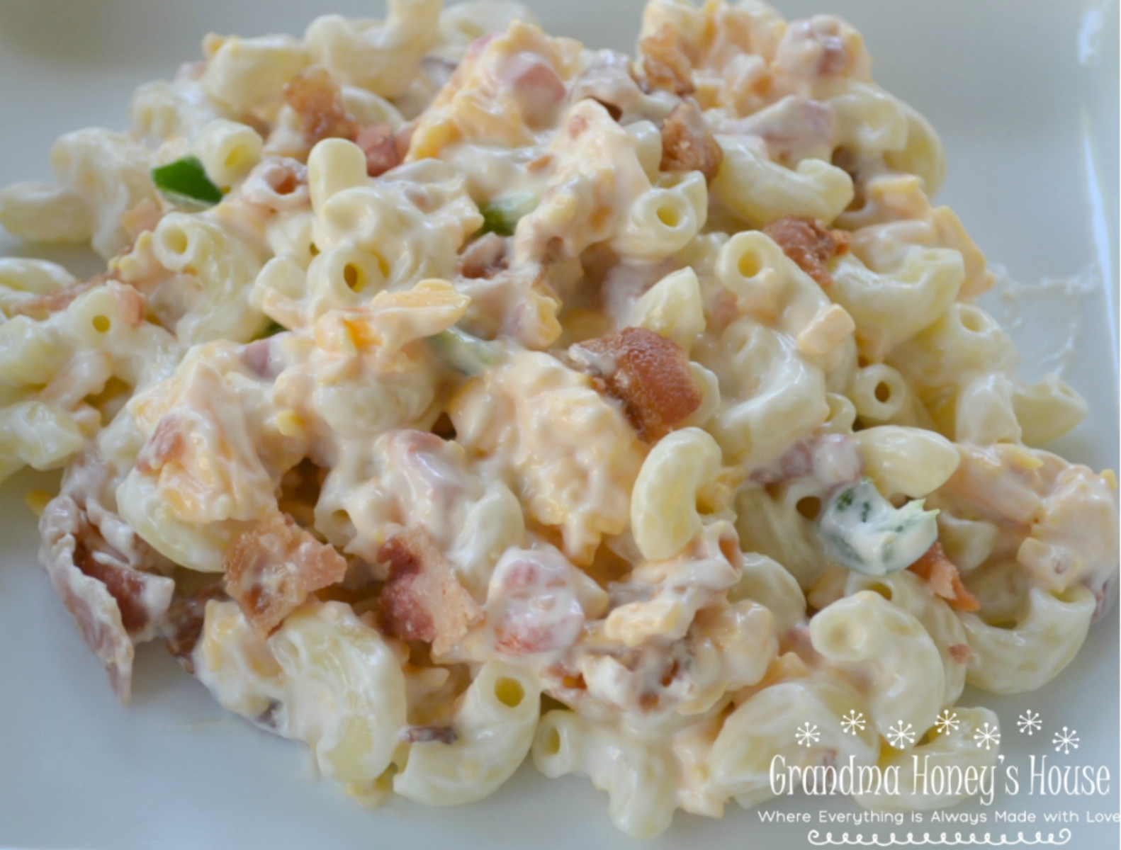 Pimento Bacon Macaroni Salad is the perfect southern style dish with a pimento cheese base, bacon, and a touch of heat from the jalapenos.