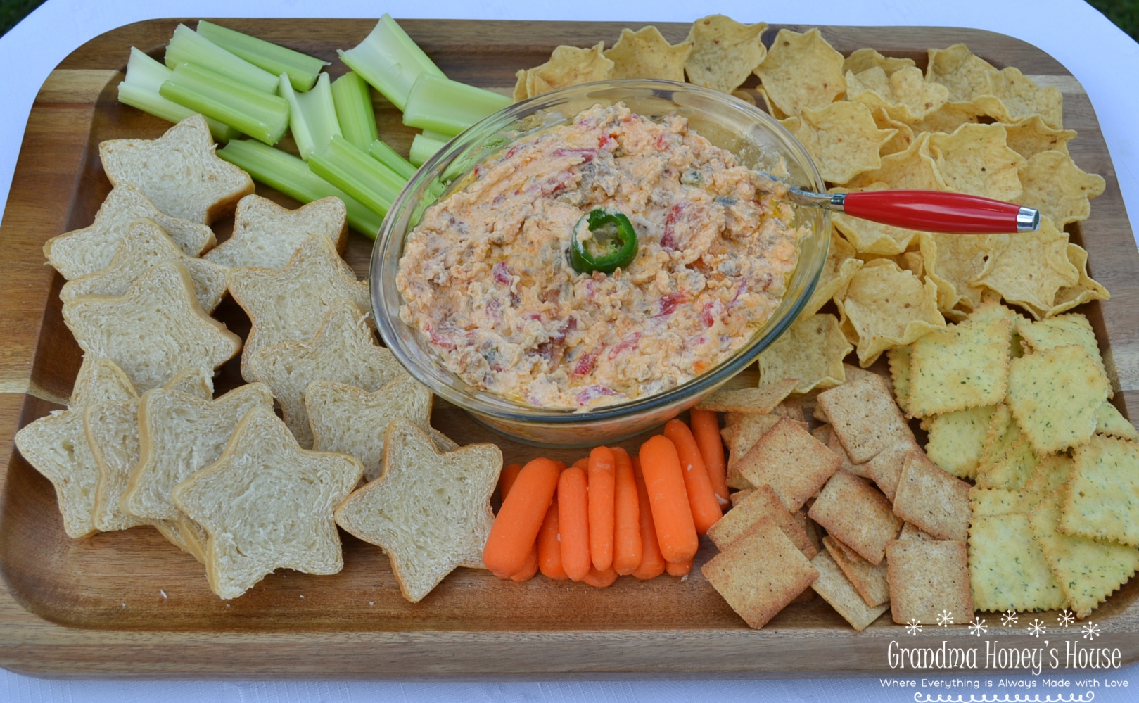 This Hot Pimento-Sausage Dip is perfect for any party. This dip has a pimento cheese base, with bacon, jalapenos, and sausage added. Perfect with chips, crackers,bread, or veggies.