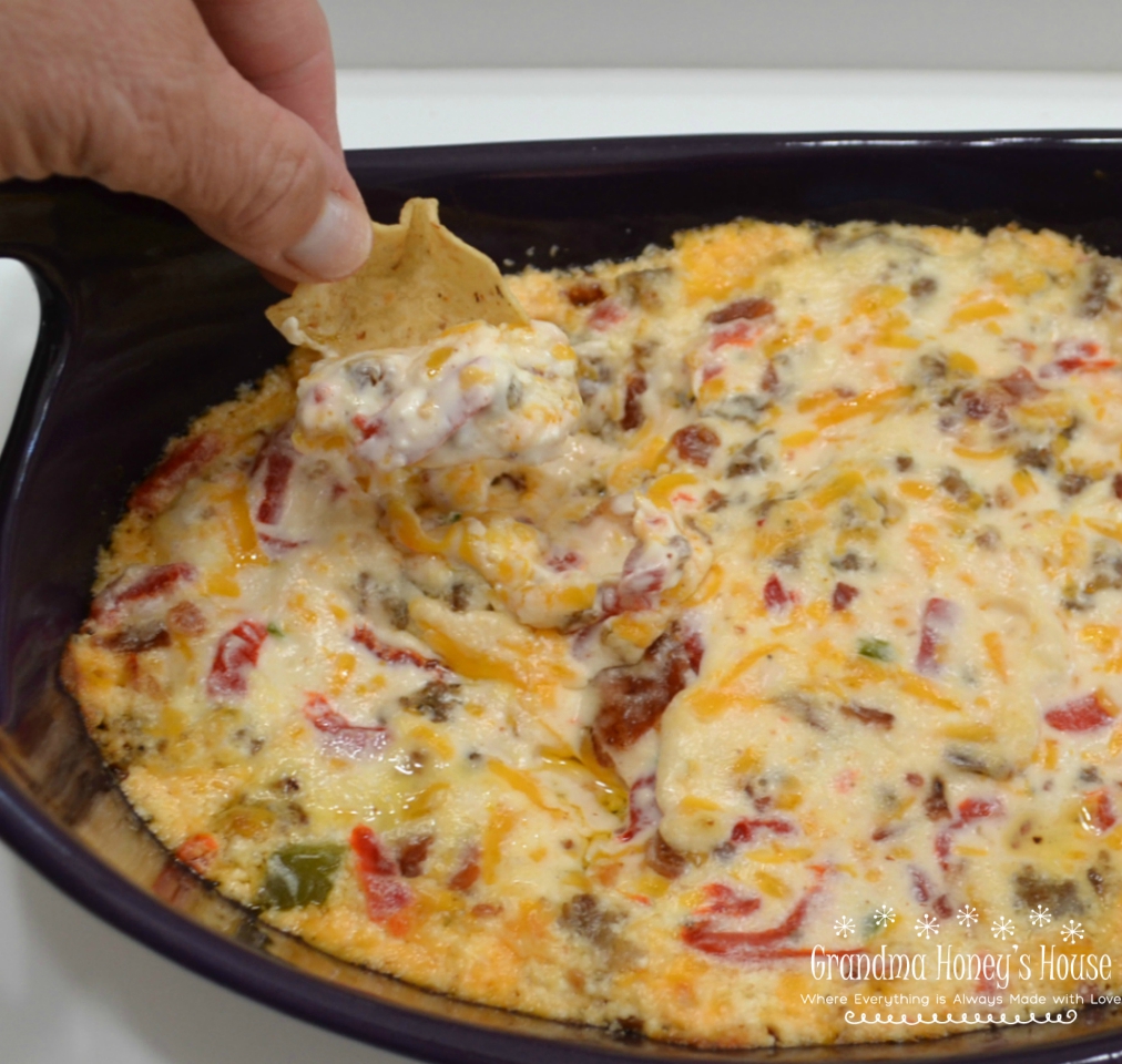 This Hot Pimento-Sausage Dip is perfect for any party. This dip has a pimento cheese base, with bacon, jalapenos, and sausage added. Perfect with chips, crackers,bread, or veggies.