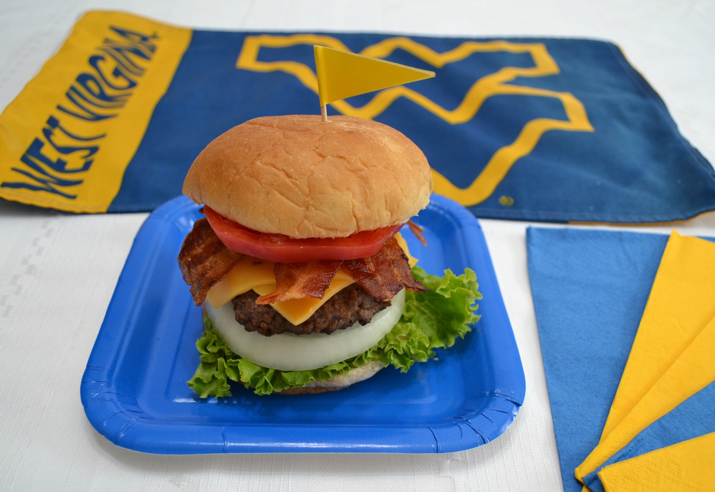 The WV Mountaineer Burger was created to honor the WVU football team and the state of WV. Perfect for tailgates. Loaded with beef, cheese and condiments.