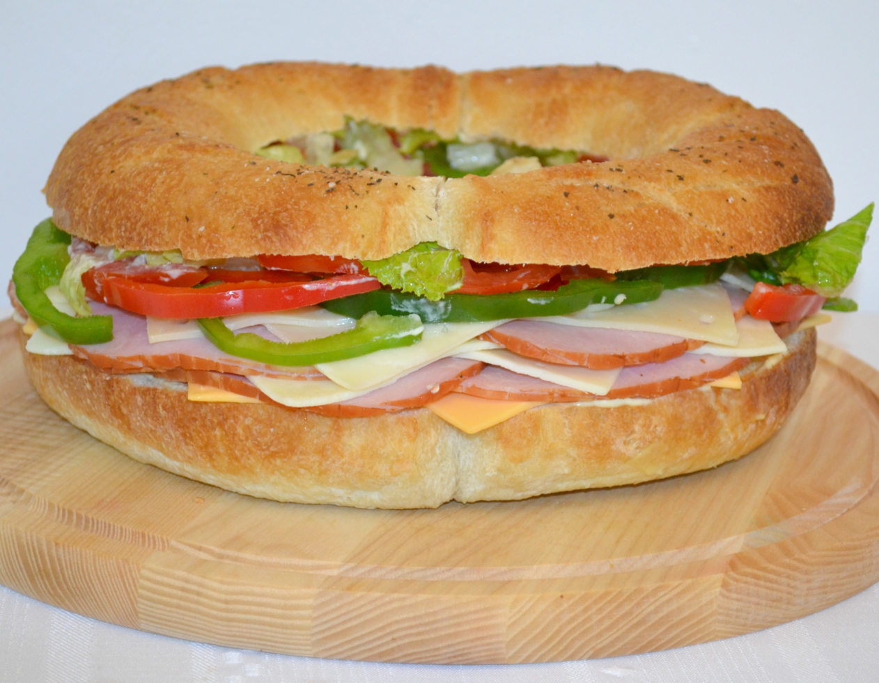 Gourmet Ham and Cheese Party Ring is perfect for any get together. A giant sandwich loaf filled with ham, cheeses, and veggies.