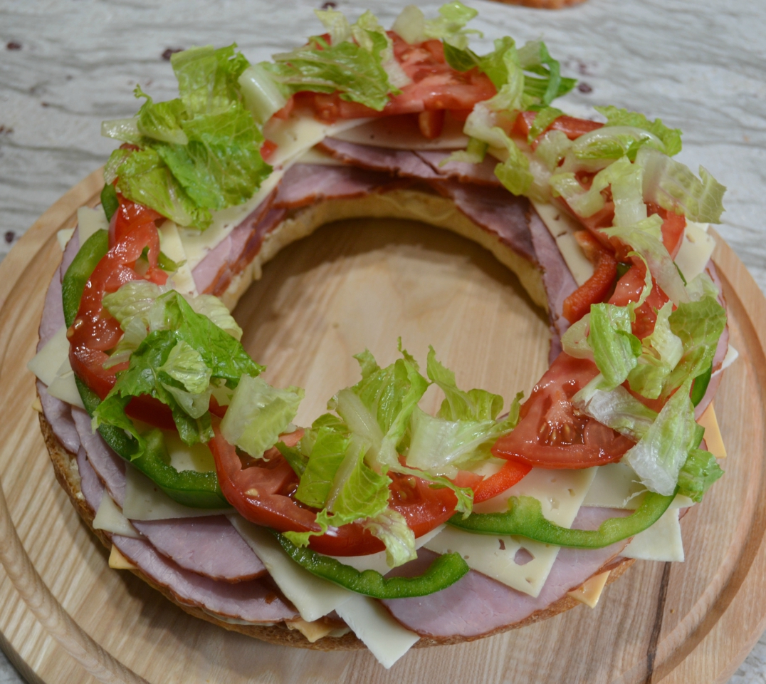 Gourmet Ham and Cheese Party Ring is perfect for any get together. A giant sandwich loaf filled with ham, cheeses, and veggies.