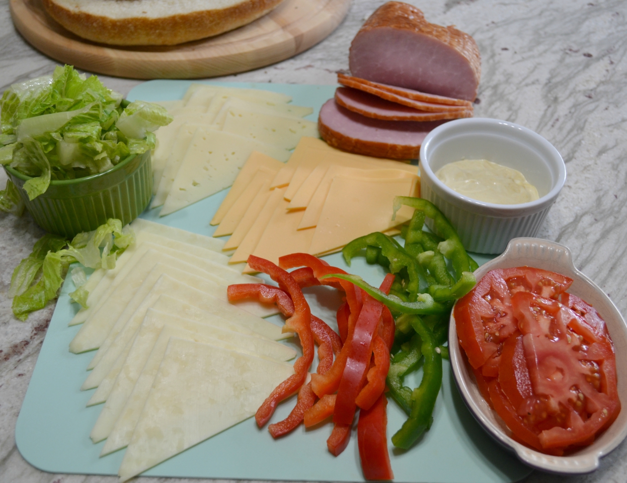 Gourmet Ham and Cheese Party Ring is perfect for any get together. A giant sandwich loaf filled with ham, cheeses, and veggies.