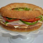 Gourmet Ham and Cheese Party Ring is perfect for any get together. A giant sandwich loaf filled with ham, cheeses, and veggies.