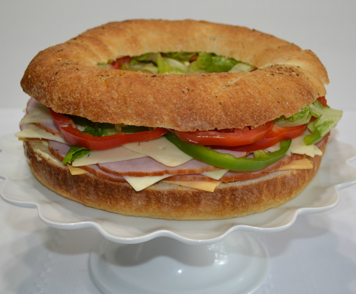 Gourmet Ham and Cheese Party Ring is perfect for any get together. A giant sandwich loaf filled with ham, cheeses, and veggies.