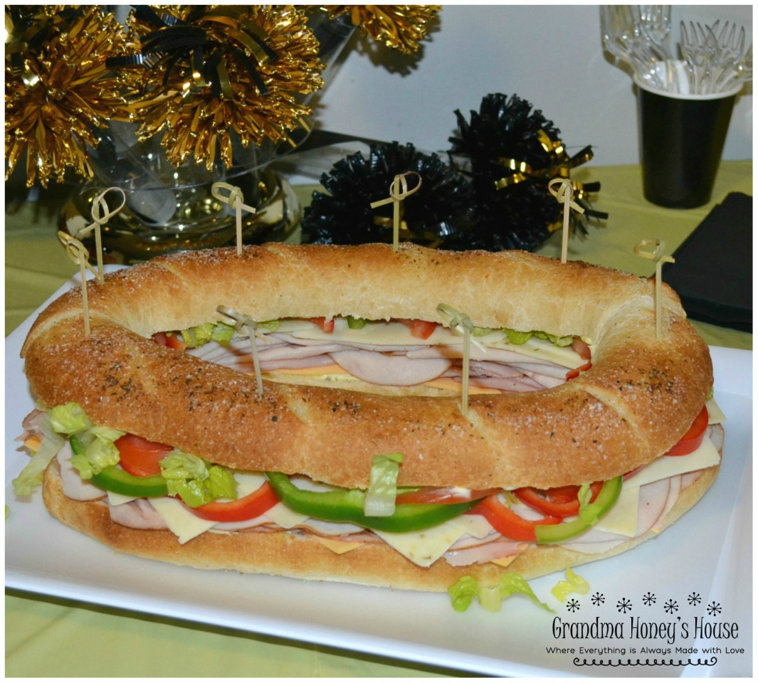 Gourmet Ham and Cheese Party Ring is perfect for any get together. A giant sandwich loaf filled with ham, cheeses, and veggies.