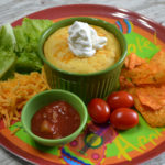 Cornbread Topped Taco Pot Pie is a ramekin filled with a taco meat filling, salsa, cheese, and then covered with a cornbread topping.