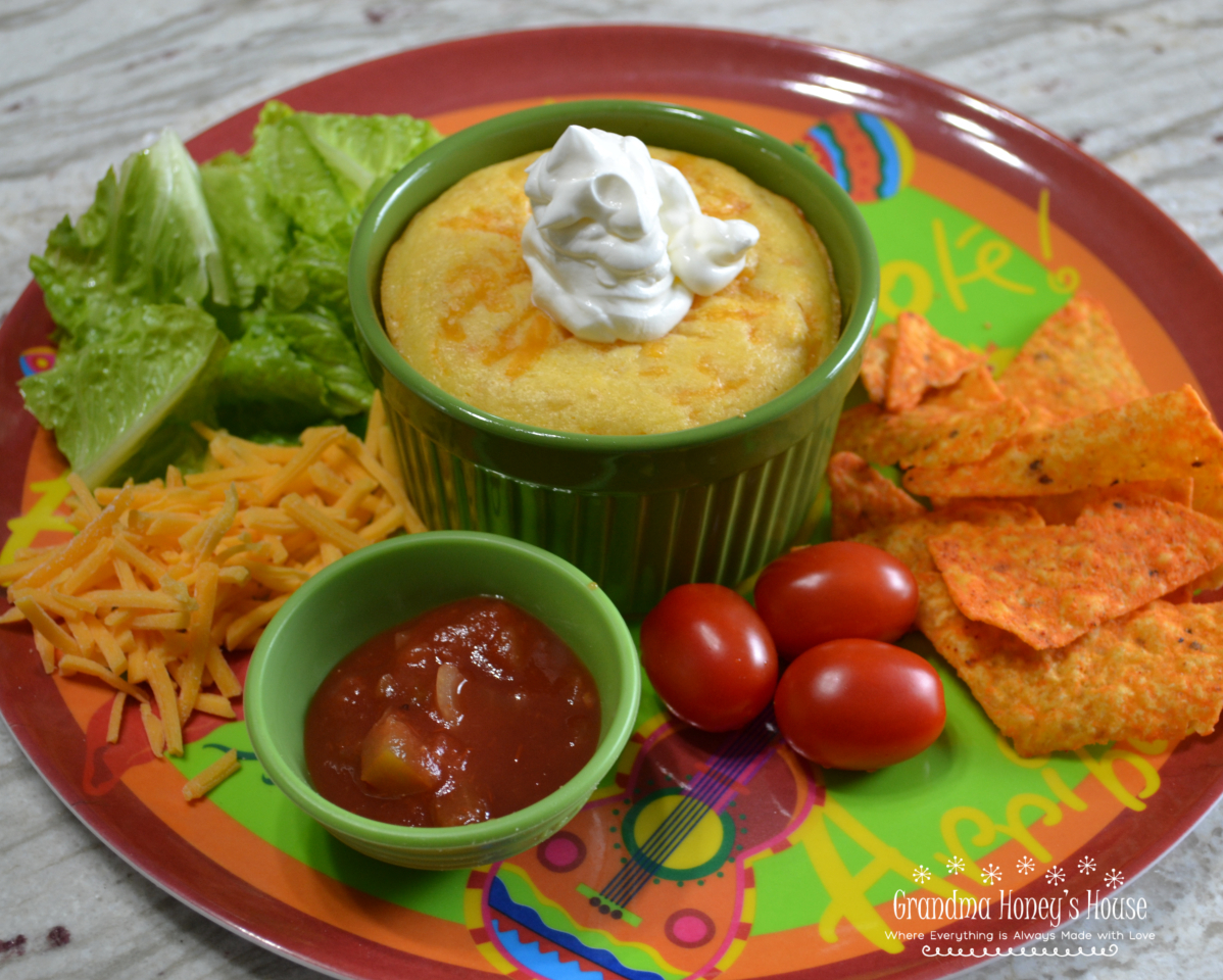 Cornbread Topped Taco Pot Pie is a ramekin filled with a taco meat filling, salsa, cheese, and then covered with a cornbread topping. 