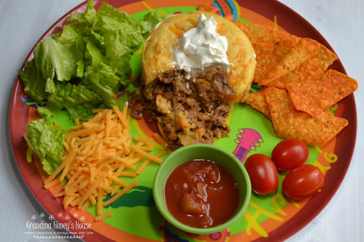 Cornbread Topped Taco Pot Pie is a ramekin filled with a taco meat filling, salsa, cheese, and then covered with a cornbread topping.